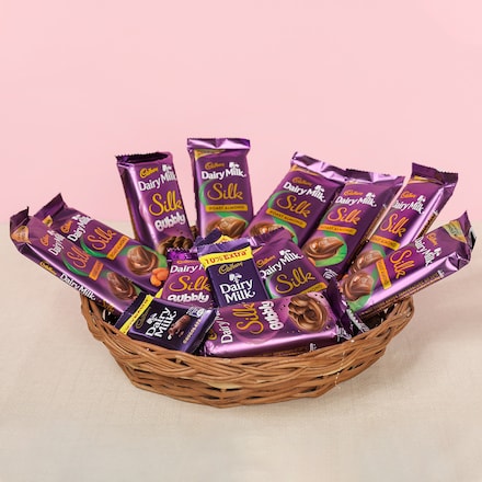 The Silk Collection Basket with assorted Cadbury Dairy Milk Silk and Silk Bubbly chocolates arranged in a wicker gift basket