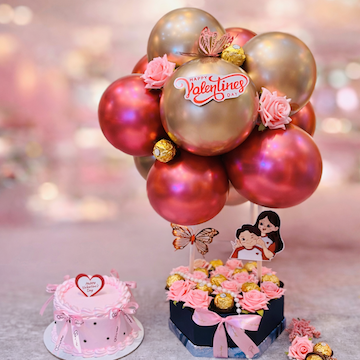 Valentine celebration combo with strawberry cake, Ferrero chocolates, pink roses and rose gold balloons