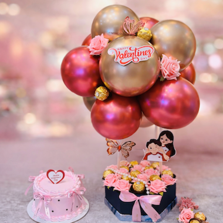 Valentine celebration combo with strawberry cake, Ferrero chocolates, pink roses and rose gold balloons