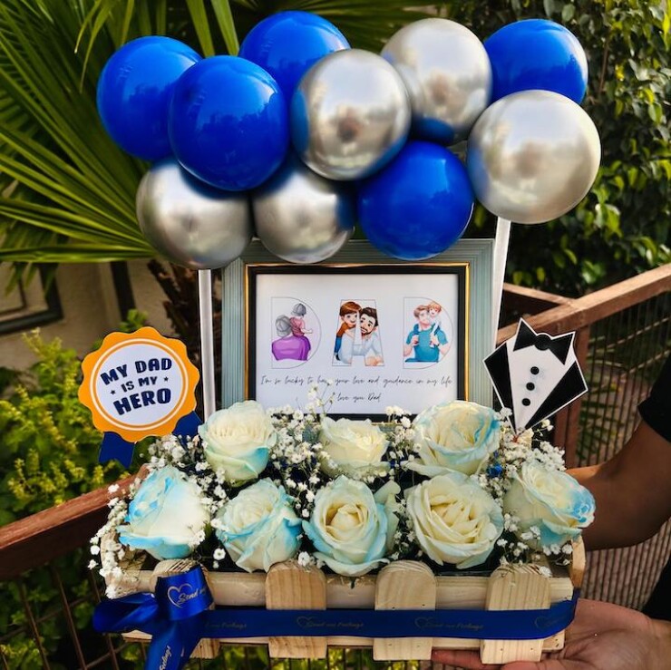 My Dad My Hero Floral Basket with blue silver balloons, 5x7 photo frame, white roses, baby's breath and Fathers Day decorations by Send My Feelings.