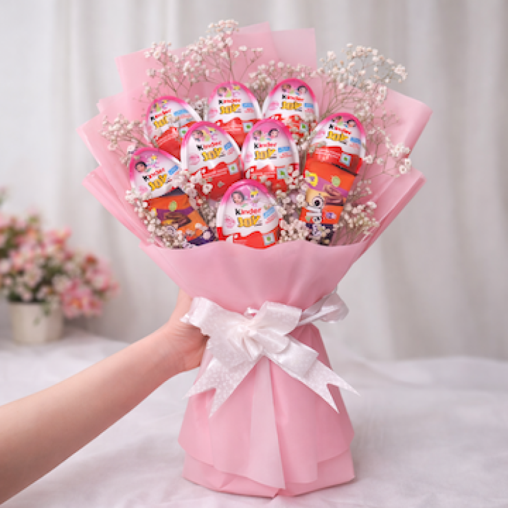 Sweet Joy chocolate bouquet with 8 Kinder Joy and 2 Crispello chocolates, arranged with white baby’s breath flowers and wrapped in premium pink paper with a white ribbon, perfect for birthdays, anniversaries, and romantic gifting.
