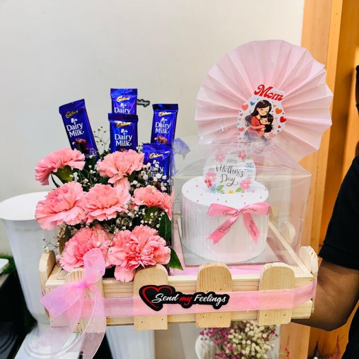 Mother’s Day basket with mini cake, pink carnations and Dairy Milk chocolates