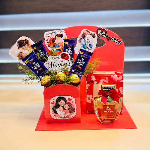 Mother’s Day acrylic red hamper with perfume, Dairy Milk chocolates, Ferrero Rocher, and decorative tags.